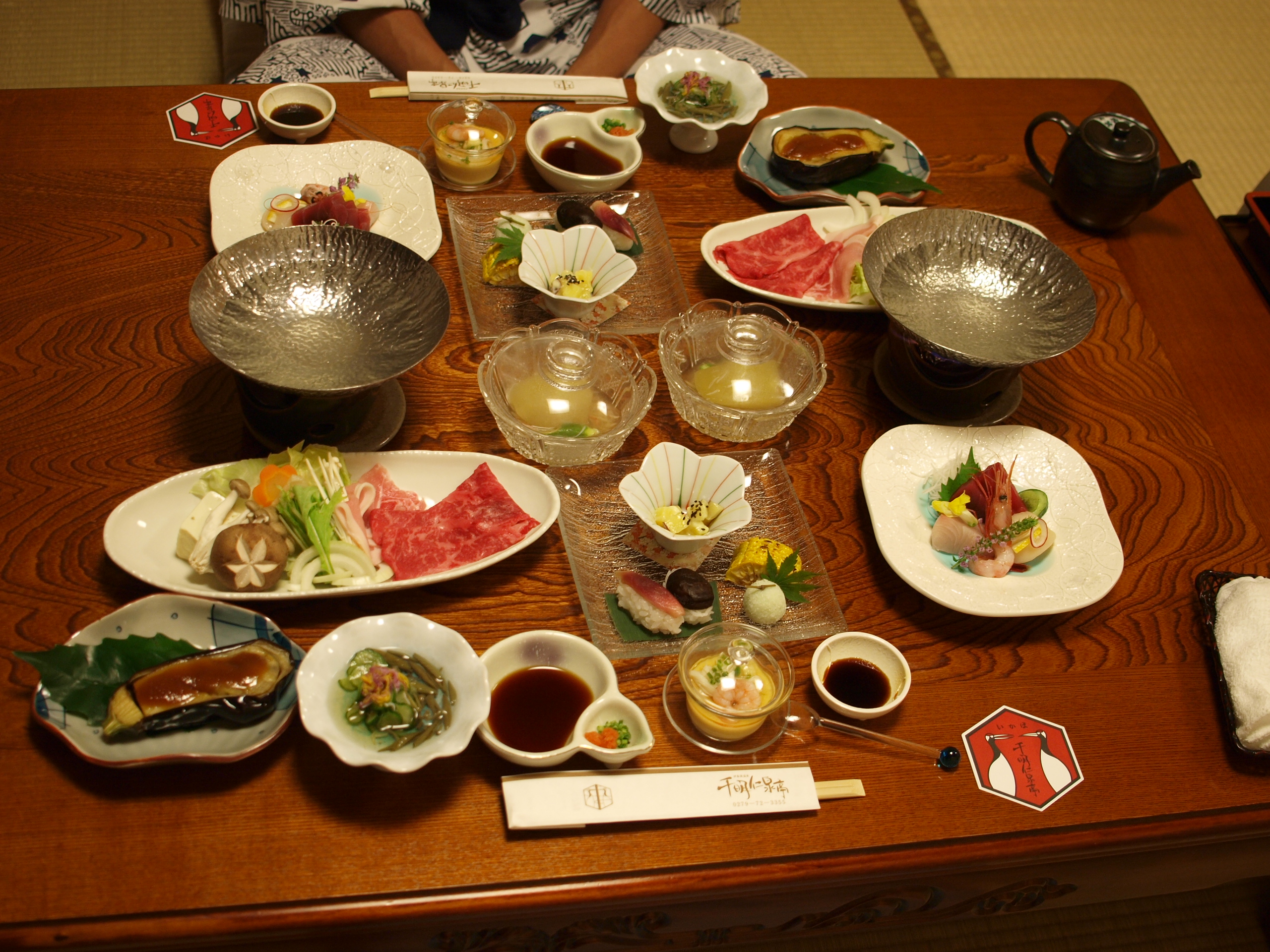 1泊2食9,800円の温泉宿の裏側!企業努力が生み出す滞在価値 1 旅館の夕食として並べられた会席料理の膳